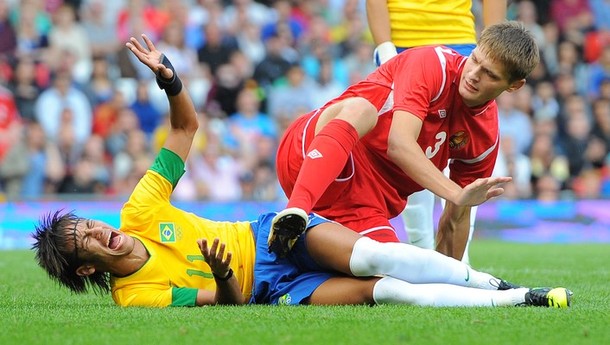 brazils_neymar_l_reacts_after_being_caught_by_belarus_igor_kuzmenok_.jpg